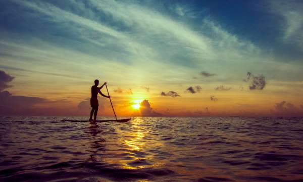 man on a SUP at sunset