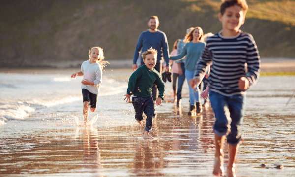 family running across beach