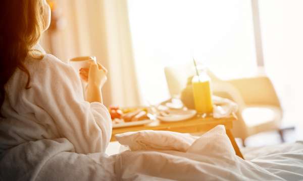 Woman Enjoying Room Service at Hotel Room