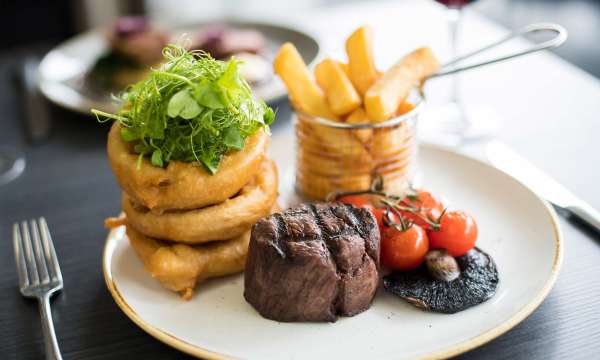 Park Hotel Restaurant Dining Beef with Onion Rings Chips Mushroom and Vine Tomatoes