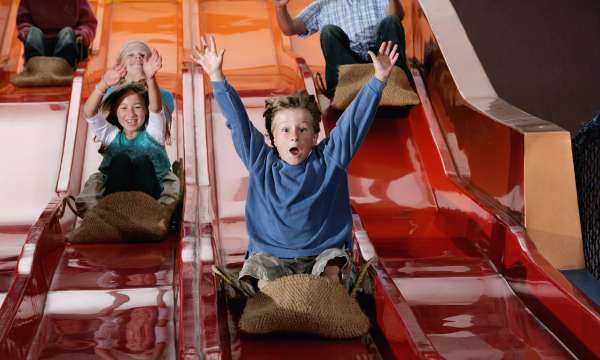 kids on a slide at Milky Way