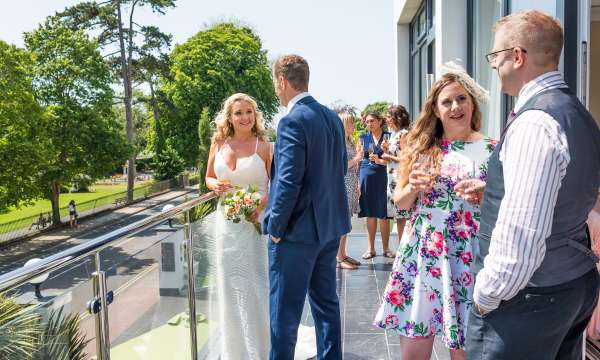 Wedding Couple and Guests at Park Suite Balcony