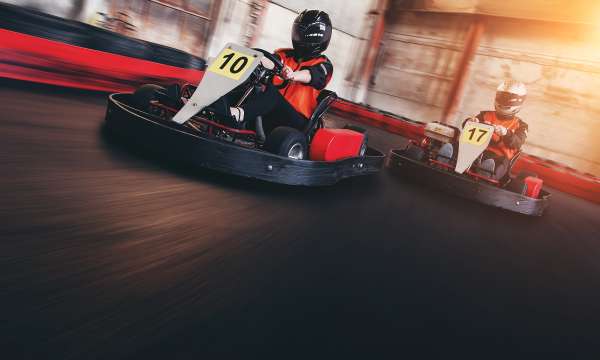 Two people racing go-karts