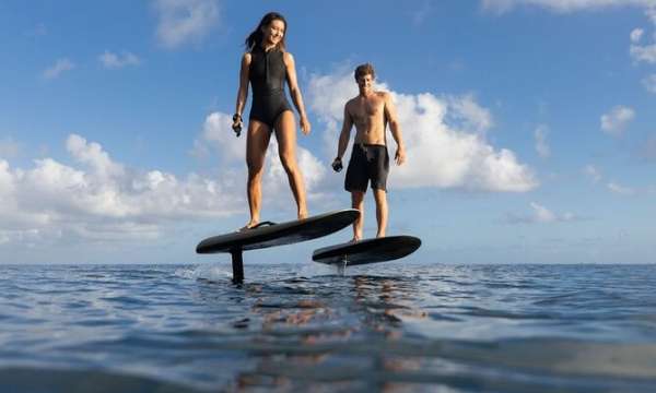 Two people on a hydrofoil board