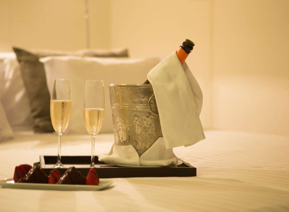 Champagne and chocolates on bed at the park hotel